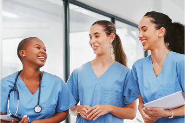 Three nurses talking and smiling